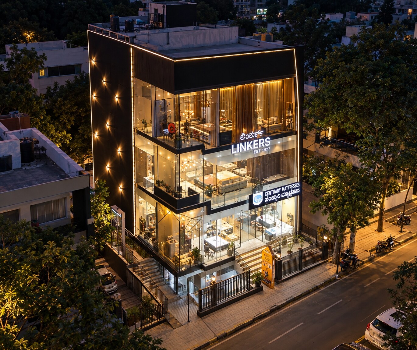 The Linkers showroom building at dusk, its lit glass floors displaying beds, seating and drapery